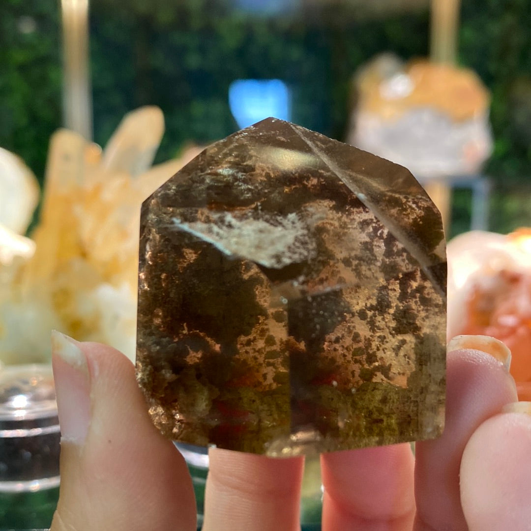 smoky crystal healing stone with clay inclusions and rutile