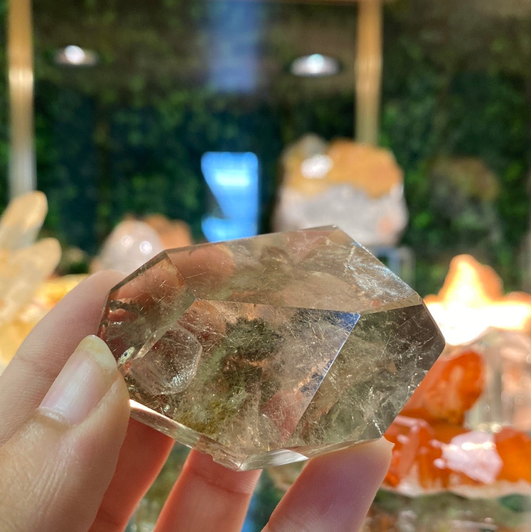 smoky crystal healing stone with clay inclusions and rutile